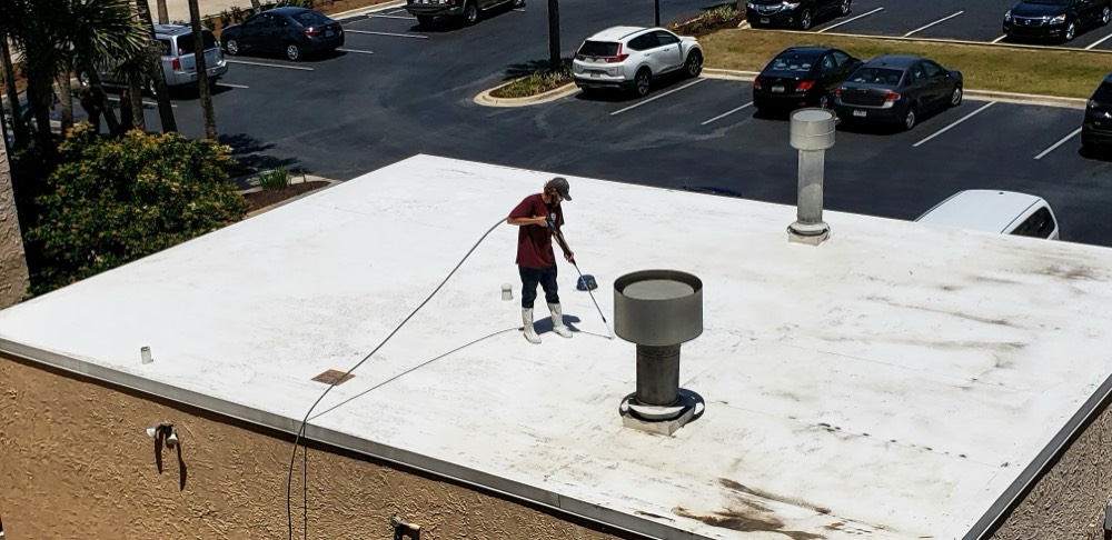 Cleaning a commercial building roof above a parking lot