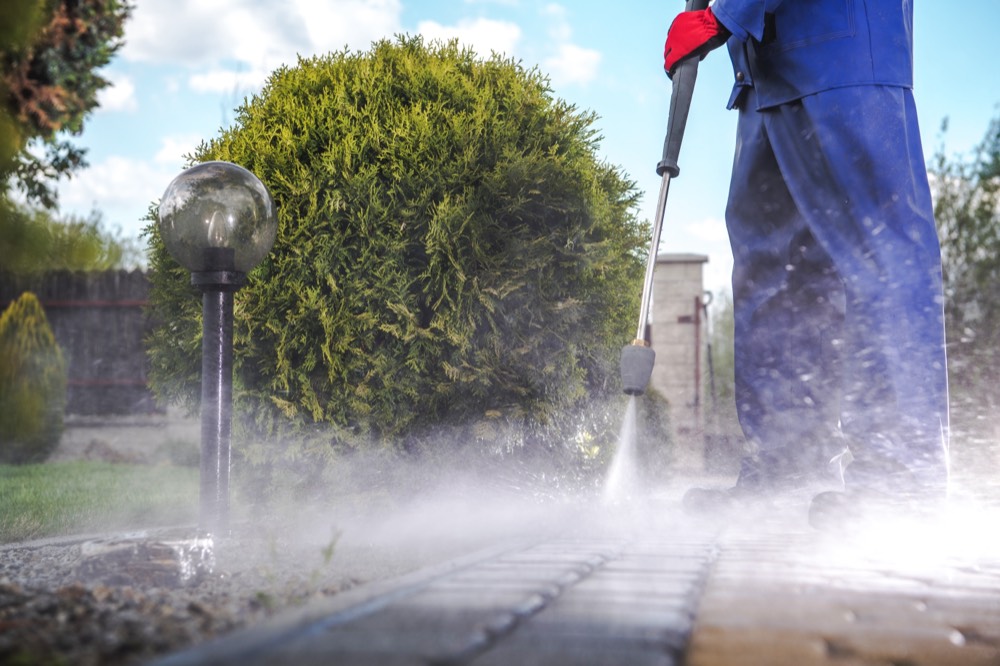 Pressure washing a residential driveway and walkway